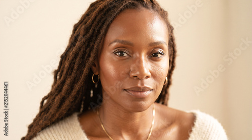 Portrait of a beautiful middle aged African American woman with dreadlocks looking at the camera.