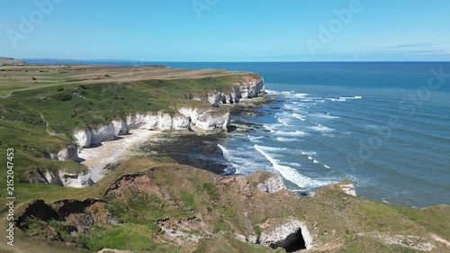 Aerial push in view of scenic Selwicks Bay chalk cliffs at Flamborough Head, England
