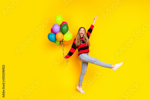 Photography Lovely young woman holding colorful balloons, stylish in casual attire with a br