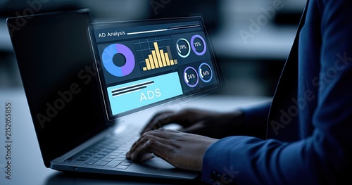 Person analyzing ad data on holographic laptop screen with graphs