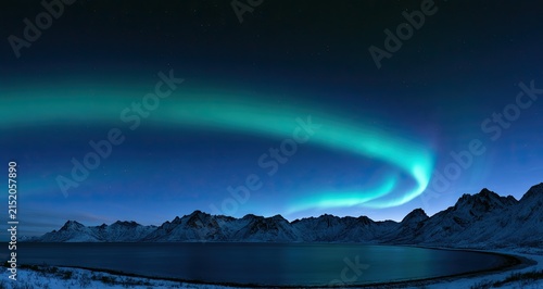 A vibrant green aurora dances over snow-capped mountains and a calm, dark bay
