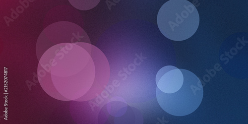 Abstract bokeh light background with soft purple and blue circles on dark textured sky.