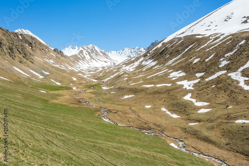 Trekking in Caucasus Mountains spring landscape. Karachay-Cherkessia, Russia
