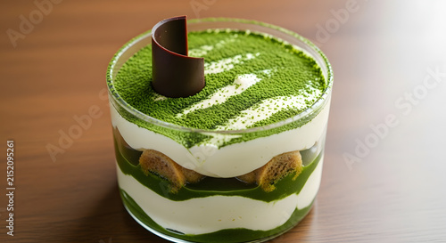 Matcha tiramisu dessert in a glass jar features layered green tea cream and sponge cake.