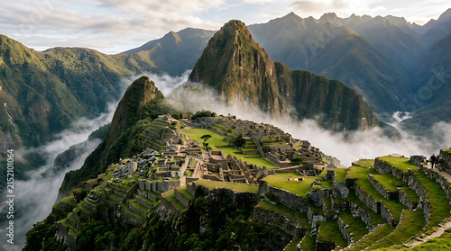 Panoramic view of the ancient Inca citadel of Machu Picchu, with its terraced fields and stone structures, surrounded by misty Andean mountains at sunrise.