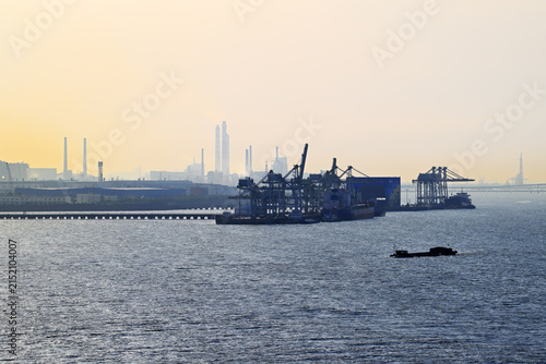 Sunset over industrial shipping port