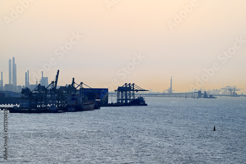 Sunset over industrial shipping port