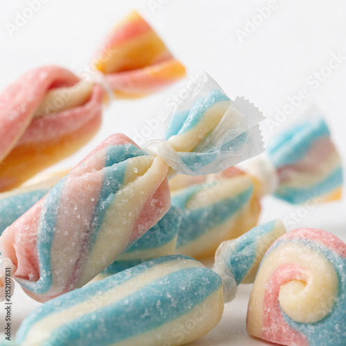 Colorful Pastel Swirl Hard Candies Wrapped Like Twists on White Background