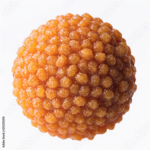 Close-up of a single textured round orange cloudberry or bramblefruit isolated on a white background