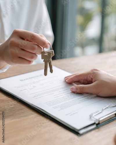 Property Manager Handing Keys to New Tenant Over Rental Agreement