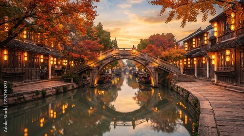 Scenic canal town in china during autumn sunset with golden light and fall foliage over stone bridge lanterns historic