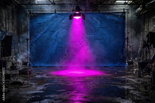 Dramatic Pink Spotlight Illuminates Dark Industrial Studio Set.