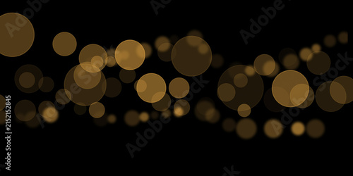 Golden bokeh light spheres float across a dark black background creating a festive glow