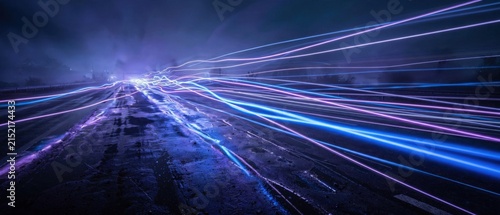 Abstract streaks of blue and purple light blur across a dark background, suggesting speed and technology.