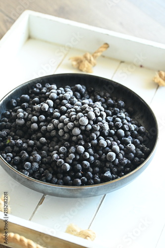фотографія Close-up macro view of frozen wild blueberries prepared as a cooking ingredient, with other fresh ingredients in the background
