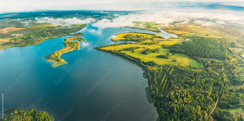 Fototapeta premium Lyepyel District, Lepel Lake, Beloozerny District, Vitebsk Region. Aerial View Of Residential Area With Houses In Countryside. Morning Fog Above Lepel Lake. Top View Of European Nature From High