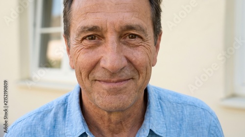 Smiling Middle-Aged Man in Casual Shirt with Warm Expression Outdoors
