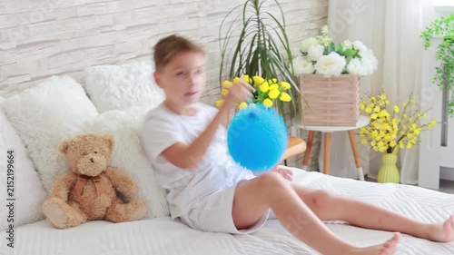 Cute preschool child, boy, playing with toys in a sunny living room