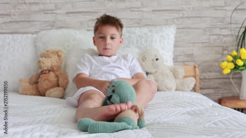 Cute preschool child, boy, playing with toys in a sunny living room