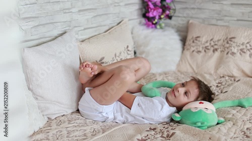 Cute preschool child, boy, playing with toys in a sunny living room