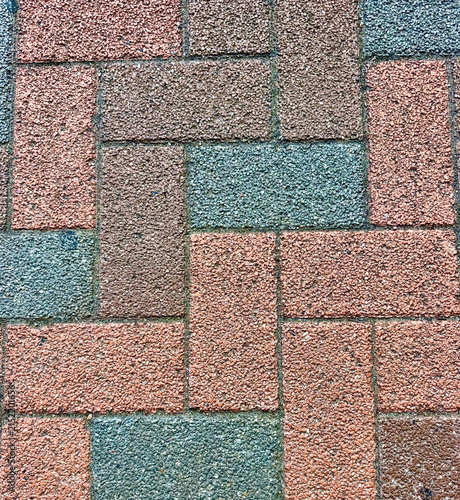 Obraz na plátně Close-up of colorful textured paving blocks arranged in a geometric pattern, creating an abstract urban background