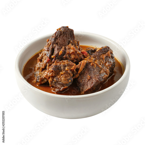 Quadro su tela Indonesian Braised Beef Rendang in Bowl Isolated on Transparent Background