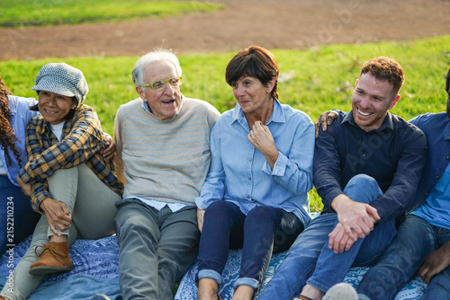 Happy multiracial people with different age having fun together at city park - Multi generational group, community and connection concept