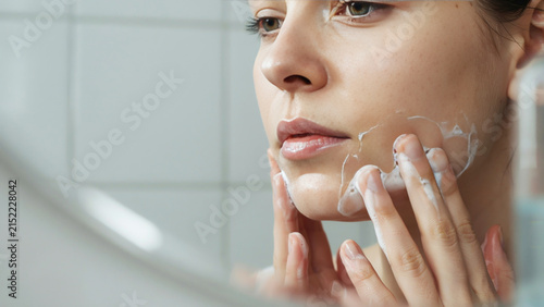 Woman applying lip balm, close-up, natural lighting, soft focus lips des