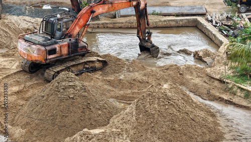 An excavator moves sand at a construction site in Handil Bakti, Banjarmasin, during the day