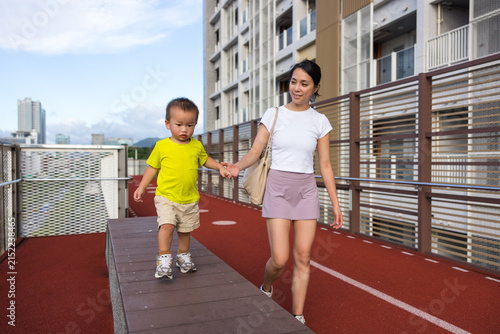 Mother and child walking outdoors together