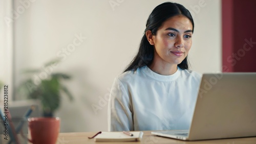 Young Woman Working on Laptop at Home Office, Remote Work and Online Business
