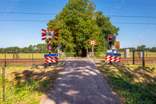 Unguarded Railway Crossing with Red Light Blinking in Heiloo, North Holland, Netherlands on summer day in August