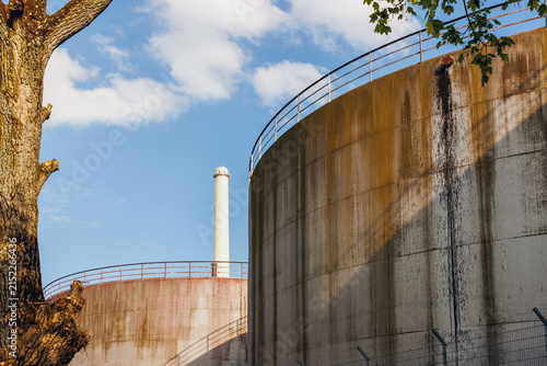 Canvas Print Weathered industrial storage tanks and smokestack at sugar factory in Ochsenfurt Germany