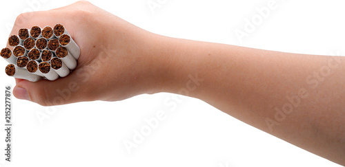 A hand is tightly gripping a handful of cigarettes with white filters and orange-yellow bodies, set against a transparent background.