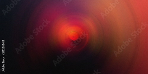 Radiant red orange circular radial blur effect creating intense glowing focus point.