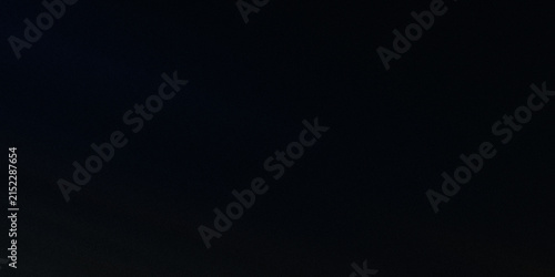 Foto Simple black background with subtle dark texture and hints of deep shadow
