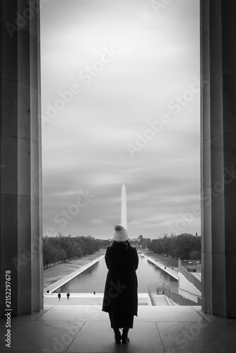 A person looking out at the Reflection pool in Washington DC