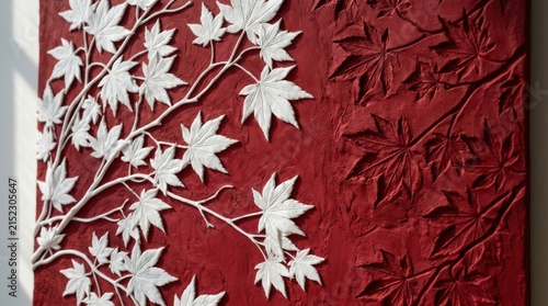 Intricate white maple leaf wall sculpture on deep red textured surface