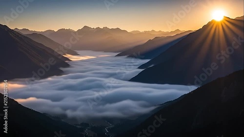 Golden sunrise illuminates a deep valley filled with thick clouds