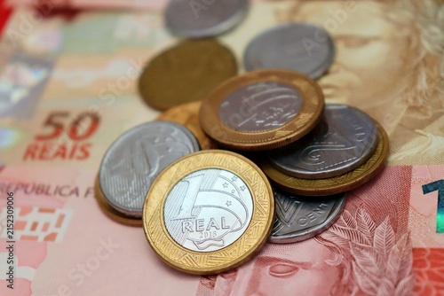 Brazilian Real banknotes and coins. Brazilian money, inflation, economy, salary, and personal finance concept.