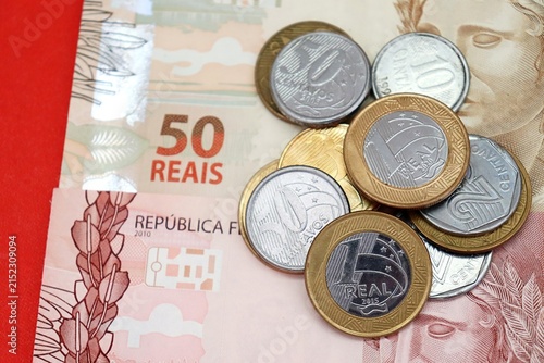 Brazilian Real banknotes and coins. Brazilian money, inflation, economy, salary, and personal finance concept.