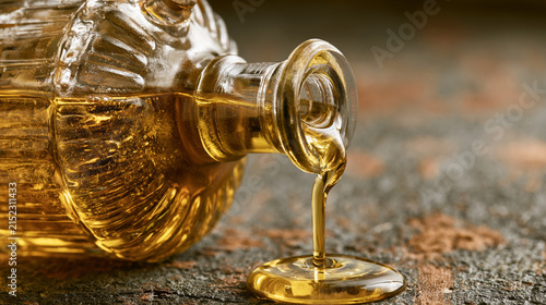 An illustration of olive oil, with olive oil pouring from a glass bottle. Rustic-style presentation.
