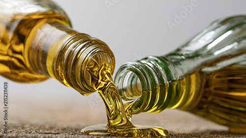 An illustration of olive oil, with olive oil pouring from a glass bottle. Rustic-style presentation.