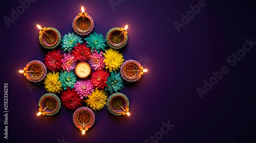 Diwali festival background with traditional clay lamps and vibrant flowers arranged in a circular pattern