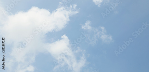 A clear blue sky with soft white clouds