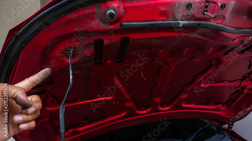 Mechanic Inspecting the Underside of a Car Hood
