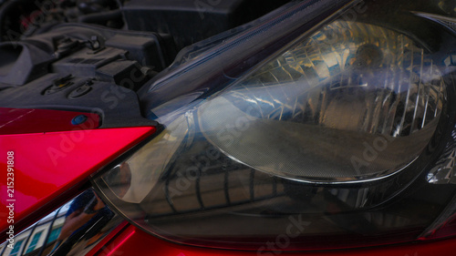 Close Up of Red Car Body and Chrome Front Grille Detail