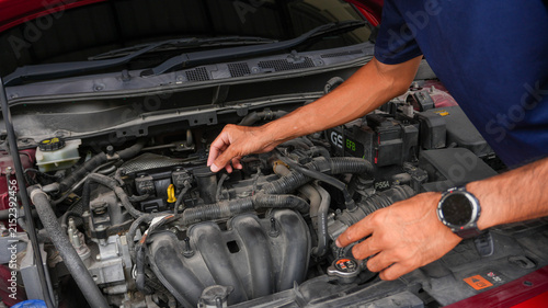 Professional Mechanic Inspecting Car Engine Under Open Hood