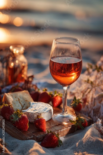 A glass of rosé wine on the seashore at sunset, Generative AI,