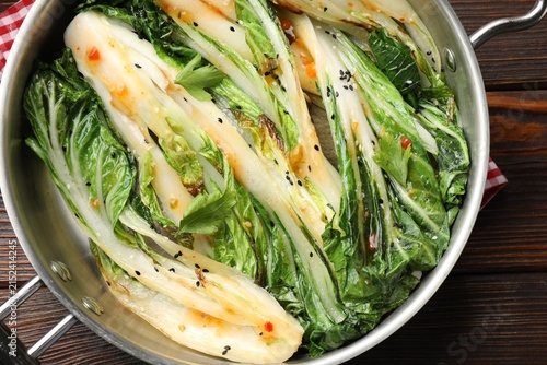 Canvastavla Tasty cooked bok choy cabbages with sesame seeds and sauce served on wooden tabl